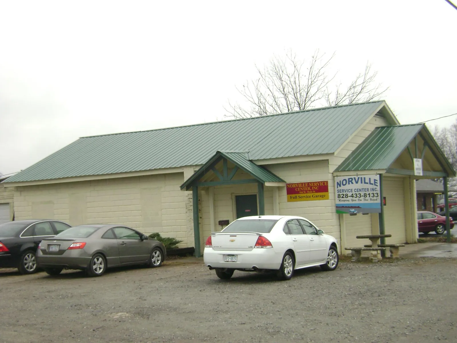 Green metal roof on a service garage with a covered entry in Salem