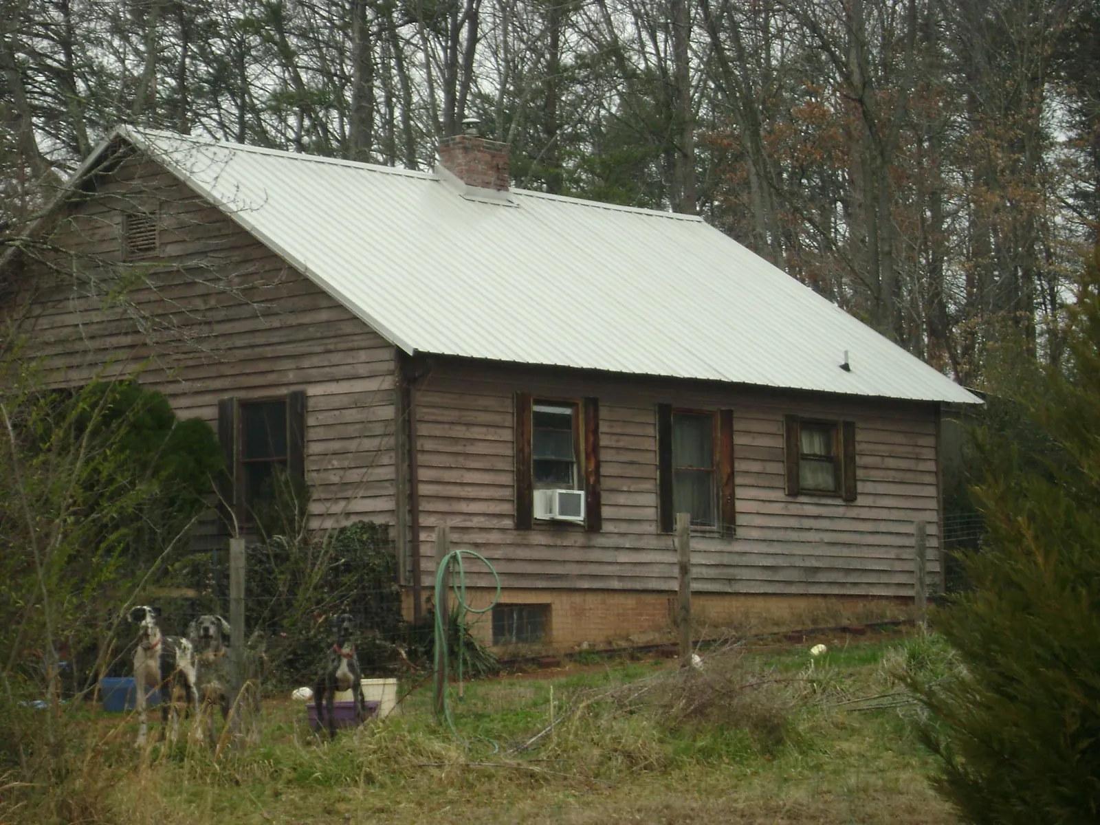 White metal roof on an old wood sided farmhouse, from a Metal Roof Installation job in Salem